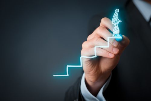 Businessman drawing stairs with person climbing.